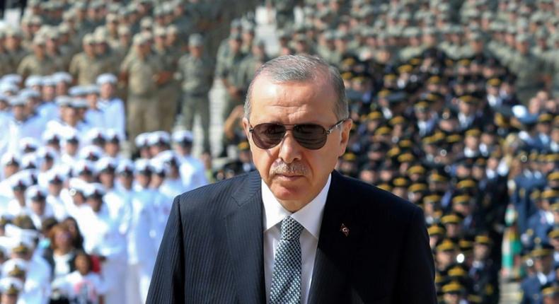 Turkish President Recep Tayyip Erdogan (C) has come under fire for undermining judicial independence