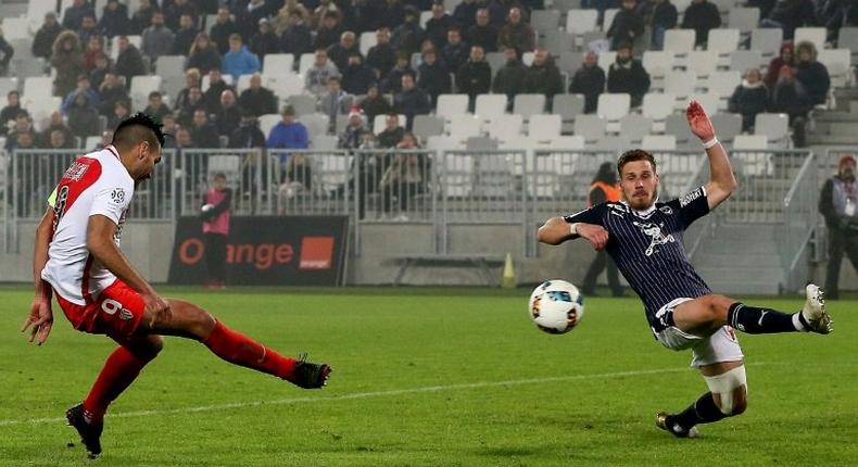 Monaco's Colombian forward Radamel Falcao (L) shoots to score a goal against Bordeaux at the Matmut Atlantique Stadium in Bordeaux, southwestern France, on December 10, 2016