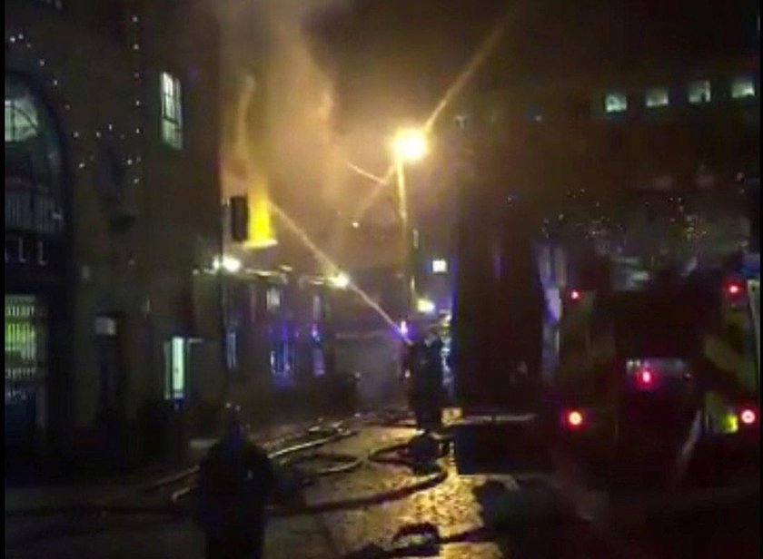 Firefighters spray water onto a fire at Camden Market in London