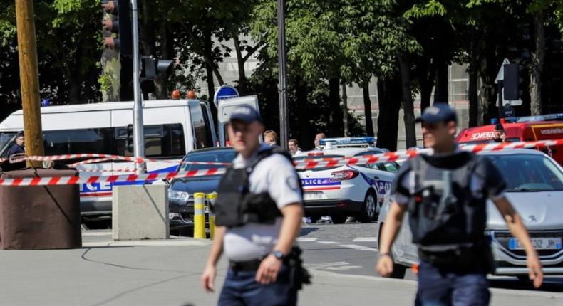 Police seal off an area of the Champs-Elysees in Paris on June 19, 2017