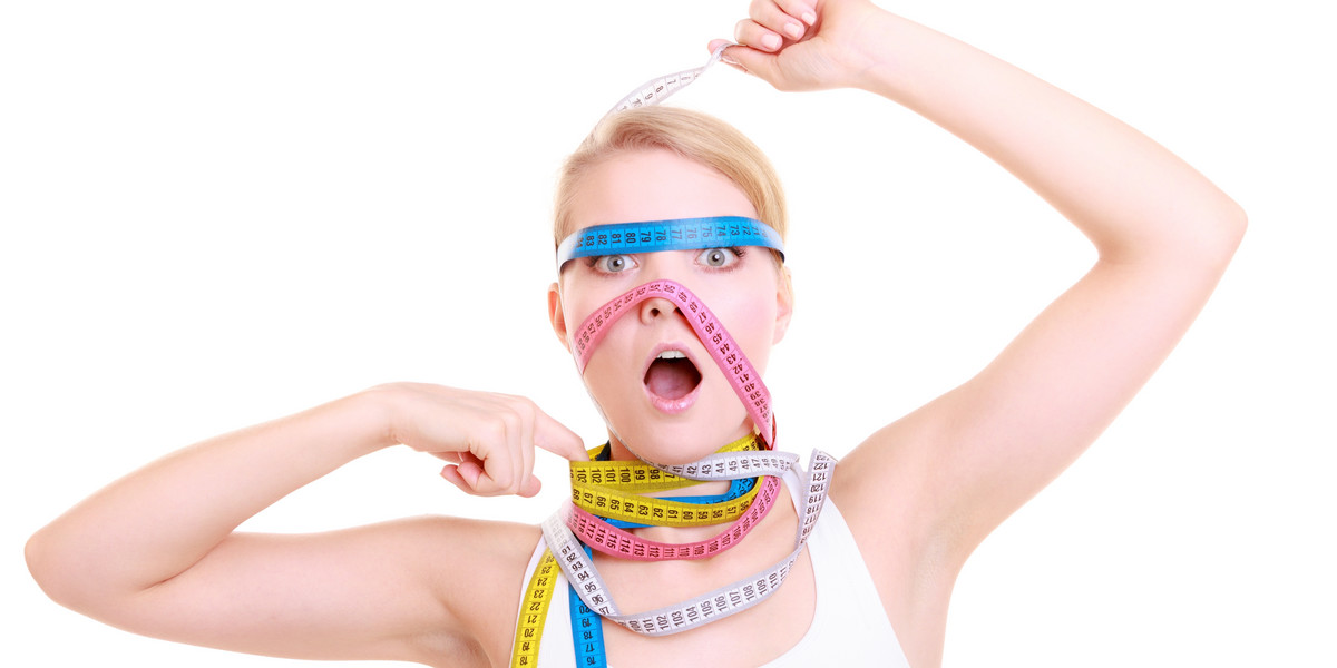 Obsessed fitness woman with a lot of colorful measure tapes