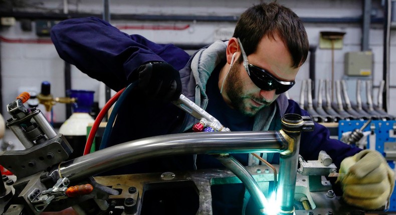 Musa Aumeed brazes a bike frame at the Brompton Bicycle factory in west London January 10, 2014. Loan refusal letters and retailers' rejections frame the walls of the Brompton Bicycle factory, a reminder of the obstacles the firm has overcome to establish itself as the UK's top bike-maker, selling 45,000 a year around the world.