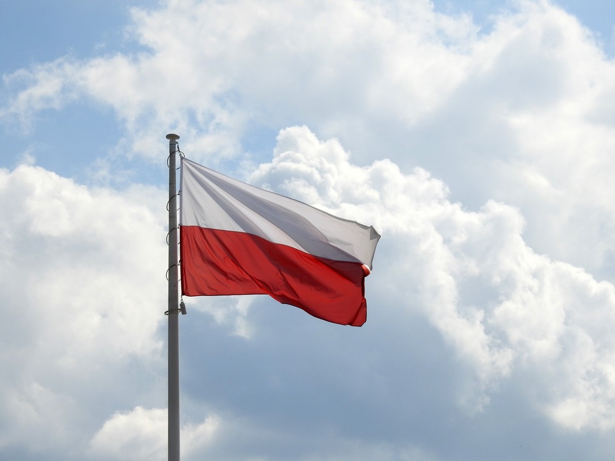 Polish,Flag,Waving,In,The,Wind,Against,With,Clouds,And
