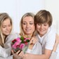 Children offering bunch of flowers on mother's 