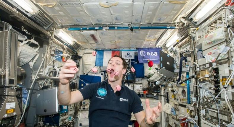 French astronaut Thomas Pesquet displays his juggling and eating skills during a light moment on the International Space Station