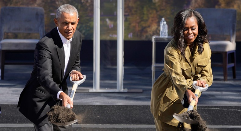 Former President Barack Obama and former first lady Michelle Obama toss shovels of dirt during a groundbreaking ceremony for the Obama Presidential Center in Chicago on September 28, 2021.
