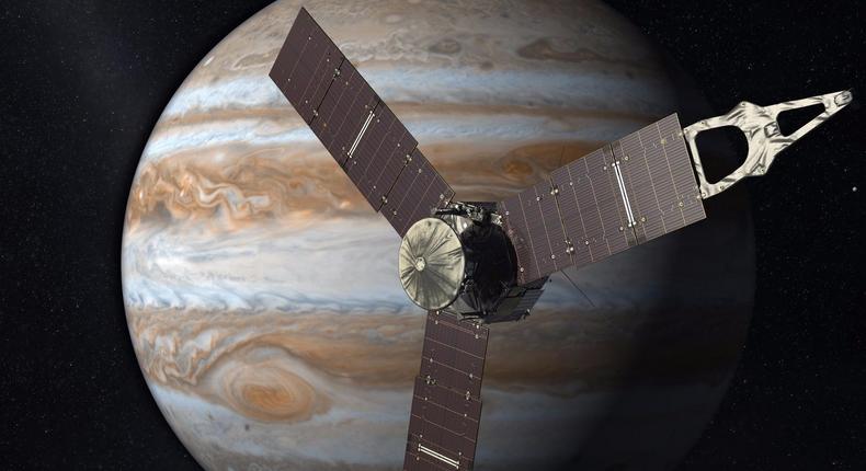 An illustration of NASA's Juno probe orbiting Jupiter.