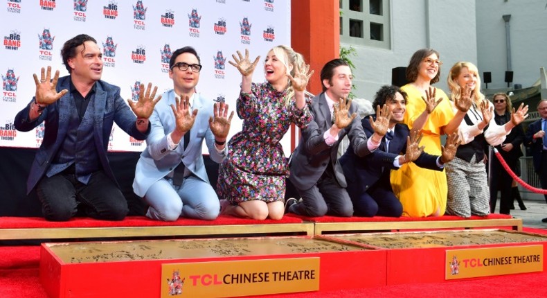 The cast of The Big Bang Theory press their handprints into the cement at the TCL Chinese Theatre