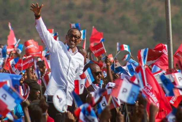 Rwandan President Paul Kagame of the ruling Rwandan Patriotic Front waves to his supporters during h