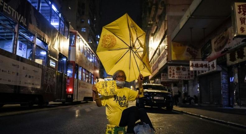 A protester holds a yellow umbrella as she protests in Hong Kong, early on November 7, 2016