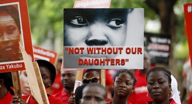 Bring Back Our Girls (BBOG) campaigners hold banners as they walk during a protest procession marking the 500th day since the abduction of girls in Chibok, along a road in Lagos August 27, 2015. REUTERS/Akintunde Akinleye