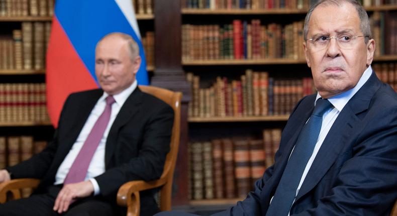 Russian Foreign Minister Sergei Lavrov looks on, next to Russian President Vladimir Putin, as they wait for the US-Russia summit at the Villa La Grange, in Geneva on June 16, 2021.