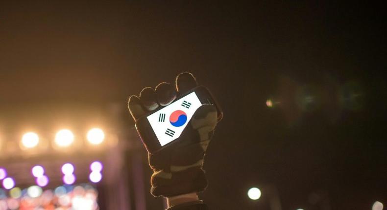 Human rights activists in South Korea, whose flag is displayed on a smartphone screen in this photo, say cases of sexual violence within the military occur persistently despite government efforts to curb them