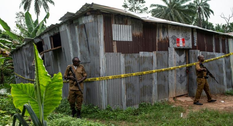 Nigerian drug enforcement officials guard a methamphetamine lab in the village of Obinugwu in the southeast of the country