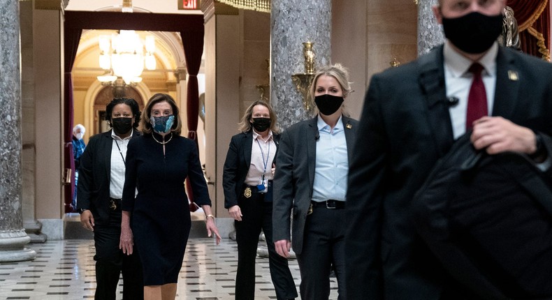 Speaker Nancy Pelosi (C), surrounded by her security detail, walks to her office from the House floor at the US Capitol on January 13, 2021 in Washington, DC.Stefani Reynolds/Getty Images