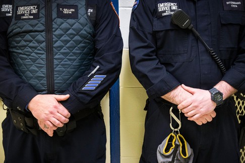 Corrections officers work in the Enhanced Supervision Housing Unit at the Rikers Island Correctional