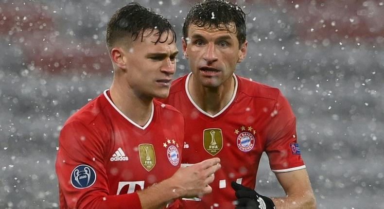 Bayern Munich midfielder Joshua Kimmich (L) is convinced the holders can still reach the Champions League semi-finals