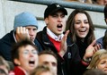 File photograph shows Britain's Prince William and his girlfriend Kate Middleton reacting during the Six Nations international rugby union match against Italy at Twickenham in London