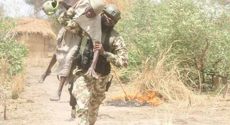 Old man rescued by soldier during a shootout between troops and Boko Haram terrorists in Gobara, Gwoza local government area of Borno state