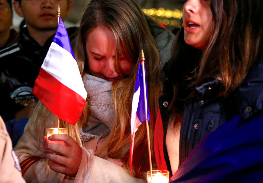 Members of the Australian French community singing the French national anthem during a vigil in central Sydney on Friday to remember the victims of the Bastille Day truck attack.
