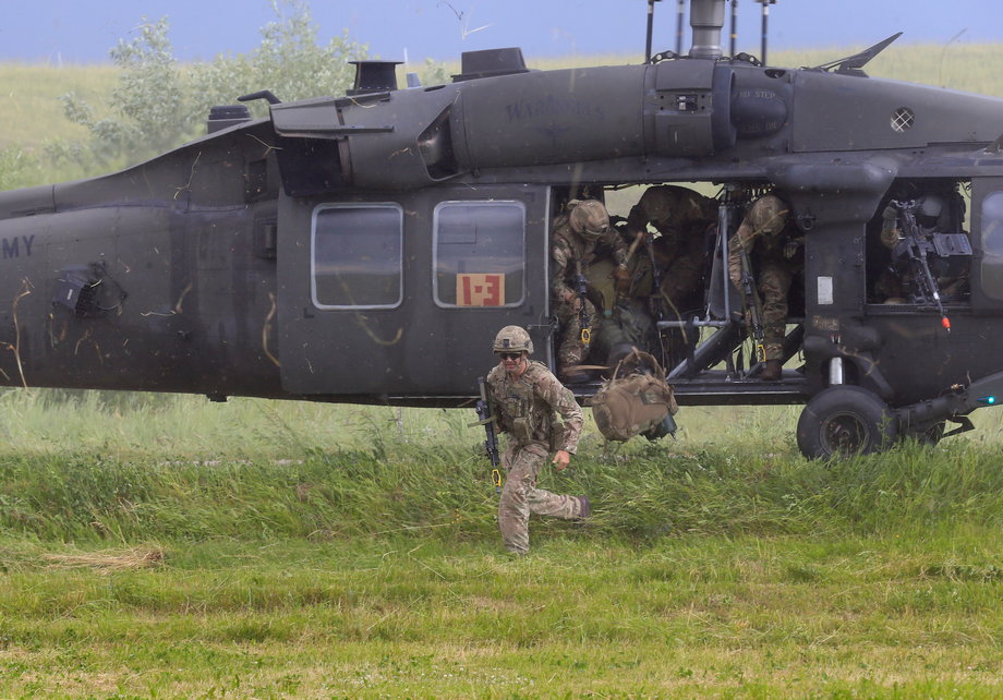 US Army soldiers leave a Black Hawk helicopter during the Suwalki gap defense exercise in Mikyciai, Lithuania, June 17, 2017.