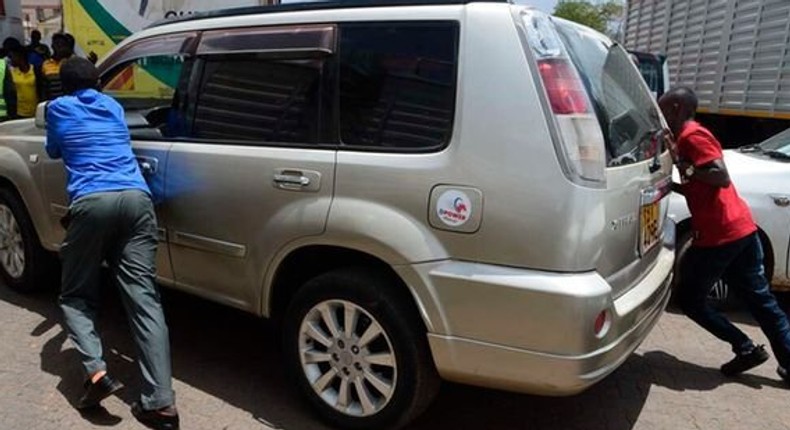 Members of the public help push a motorist whose fuel ran out while queueing at a petrol station in Eldoret town, Uasin Gishu County, on April 3, 2022. Jared Nyataya | Nation Media Group