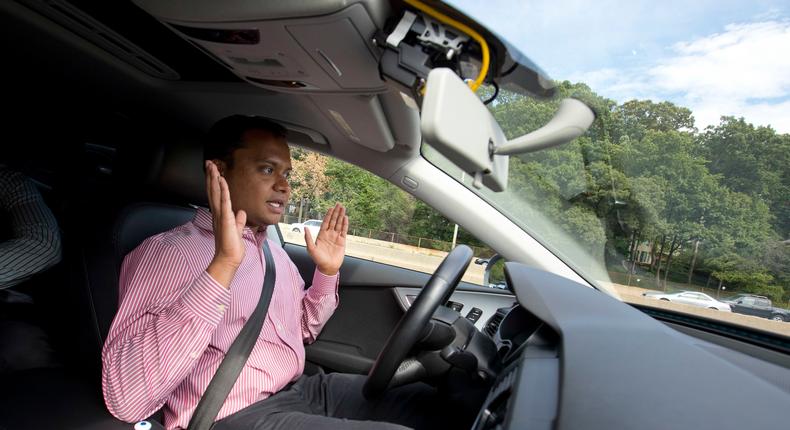 Kaushik Raghu, Senior Staff Engineer at Audi, takes his hands off the steering wheel while demonstrating an Audi self driving vehicle