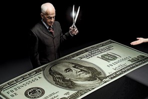 Businessman holding scissors and reaching hands around one hundred dollar bill