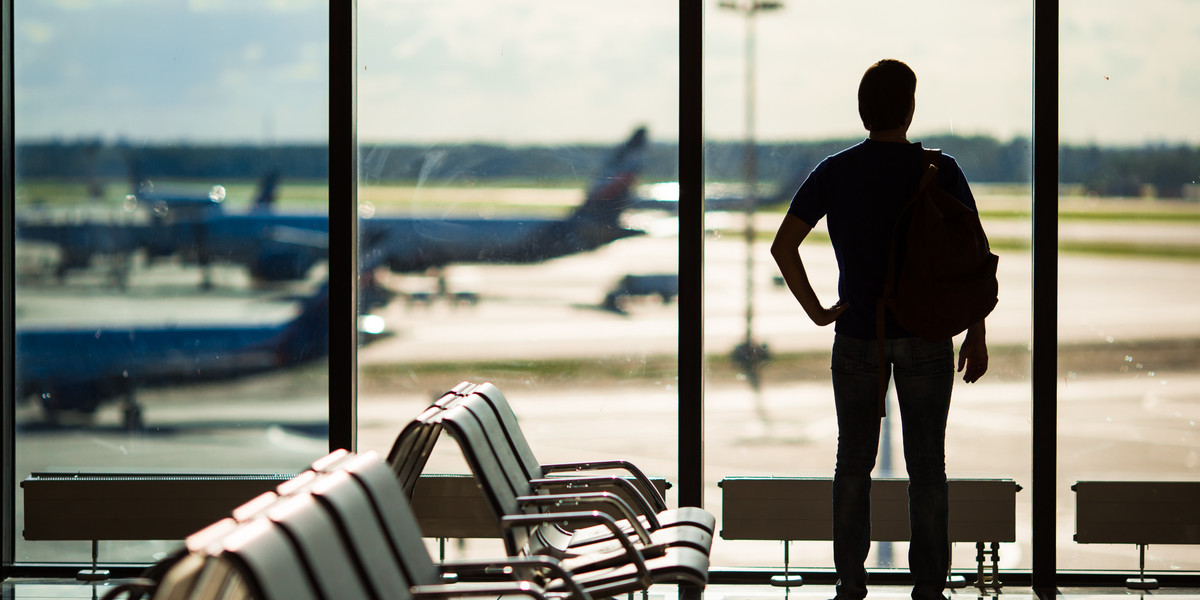 Silhouette of a man waiting to board a flight in airport