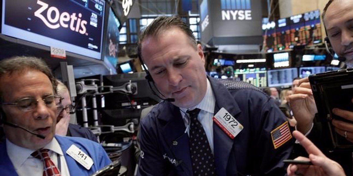 Traders work on the floor of the NYSE