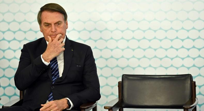 (FILES) In this file photo taken on September 06, 2019, Brazilian President Jair Bolsonaro gestures during the launching ceremony of the new student ID at Planalto Palace in Brasilia