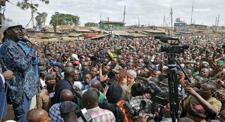 Kenya's opposition leader Raila Odinga (L) speaks in the Kibera district of Nairobi on August 13, 2017