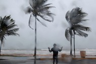 A man reacts in the winds and rain in Luquillo as Hurricane Irma slammed across islands in the northern Caribbean