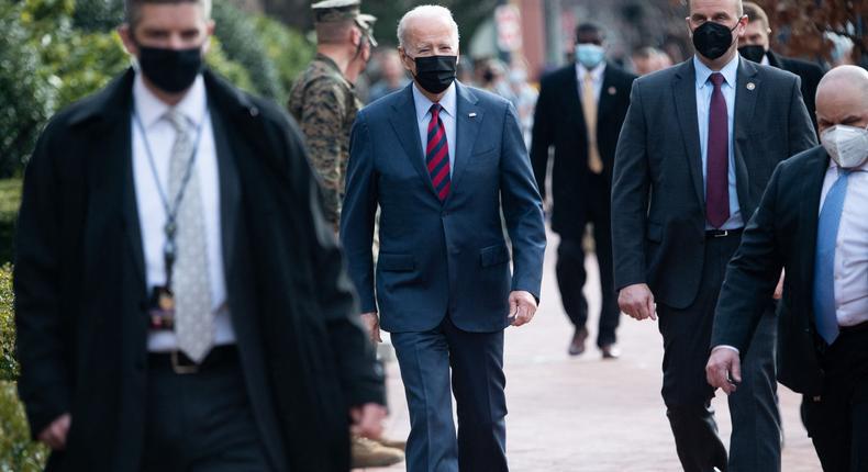 President Joe Biden, surrounded by members of the US Secret Service, makes a surprise walk down Barracks Row in Washington, DC, on January 25, 2022.