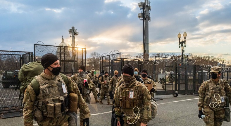 Members of the National Guard unit leave the grounds of the United States Capitol building a few days after the inauguration of President Joe Biden and Vice President Kamala Harris.