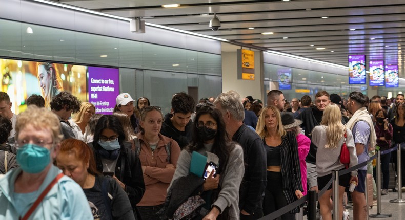 People wait in long queues for security at Heathrow Airport on June 1.