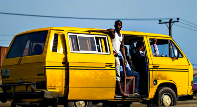 A bus conductor doing his job.