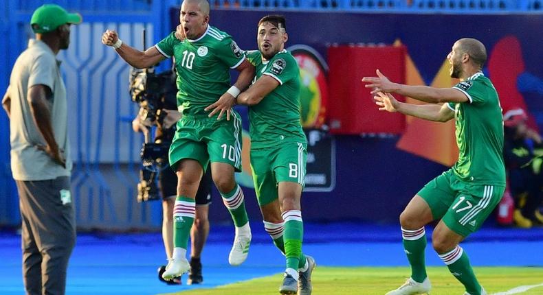 Midfielder Sofiane Feghouli (2nd-L) celebrates scoring for Algeria as Ivory Coast coach Ibrahim Kamara (L) looks on during an Africa Cup of Nations quarter-final in Egypt