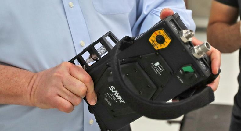 James W. Teetzel, CEO and founder of American defence manufacturer Wilcox, holds a medical ventilator at Qatar's Barzan facility, in the capital Doha