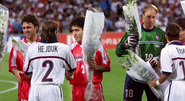 Iranian players offer flowers to US players before a politically charged match in Lyon, France during the 1998 World Cup Creator: PATRICK KOVARIK