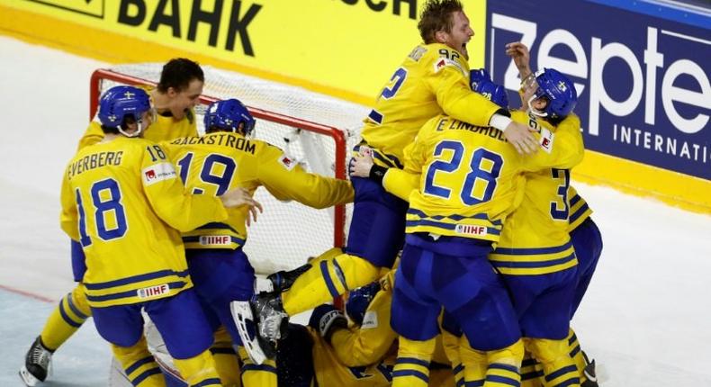 Sweden's players celebrate after winning the penalty shoot-out of the IIHF Men's World Championship Ice Hockey final match on May 21, 2017