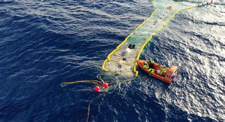 An offshore Ocean Cleanup crew visits the new device in the ocean.
