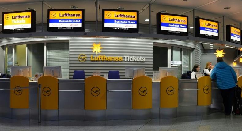 A flight passenger stands at a counter of German airline Lufthansa, as the pilots plan to continue their strike, following a dispute concerning wages that ended without a resolution