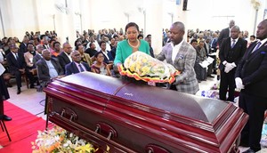 Deputy Speaker Thomas Tayebwa and his wife laying a wreath on Kahenano's remains