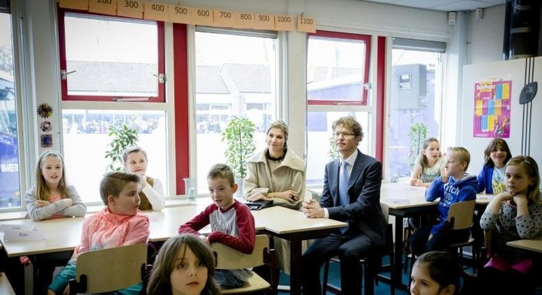 Dutch Queen Maxima and Dutch state secretary of education Sander Dekker sit in on a lesson at an elementary school--Dekker refused to grant an Islamic school funding after a member of the board voiced support for the Islamic State