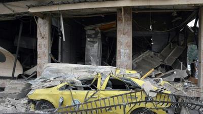 A May 23, 2017 picture from Syria's official SANA news agency shows the aftermath of a reported car bombing near the Al-Zahraa neighbourhood of Homs city