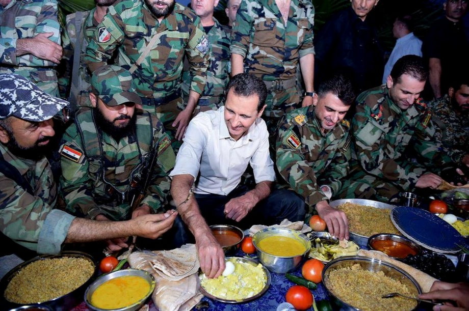 Syria's President Bashar Assad joins Syrian army soldiers for Iftar in the farms of Marj al-Sultan village.