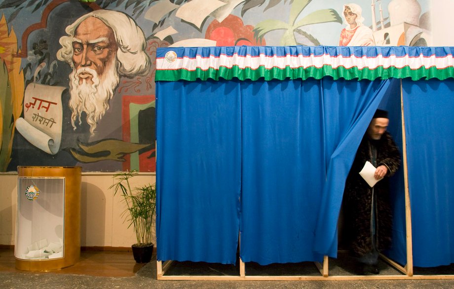 A man leaves an electoral booth at polling station in Tashkent, Uzbekistan.