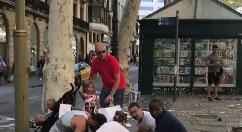 This video grab obtained from the instagram account carlos_tg_32_ shows people tending to an injured woman after a van ploughed into the crowd on Barcelona's popular Las Ramblas boulevard.