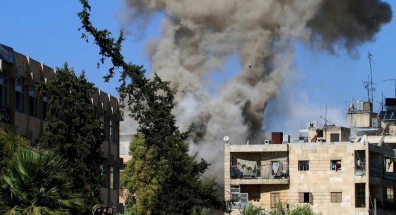 Smoke rises from reported opposition fire from buildings in an eastern government-held neighbourhood of the northern Syrian city of Aleppo